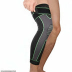 Compression knee support sleeve with strap and green accents on a person's leg